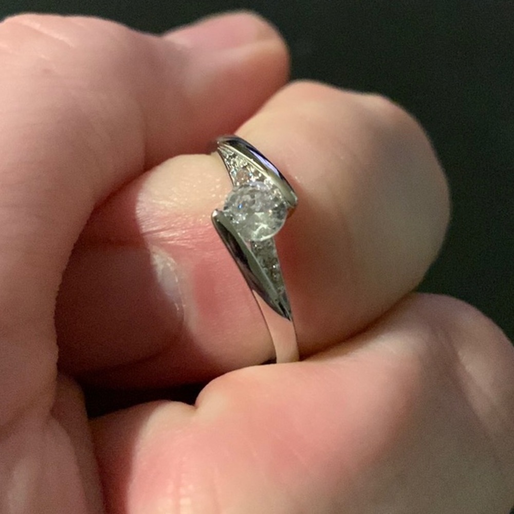 .925 silver ring, unknown size. Diamonds are not real, beautiful ring.